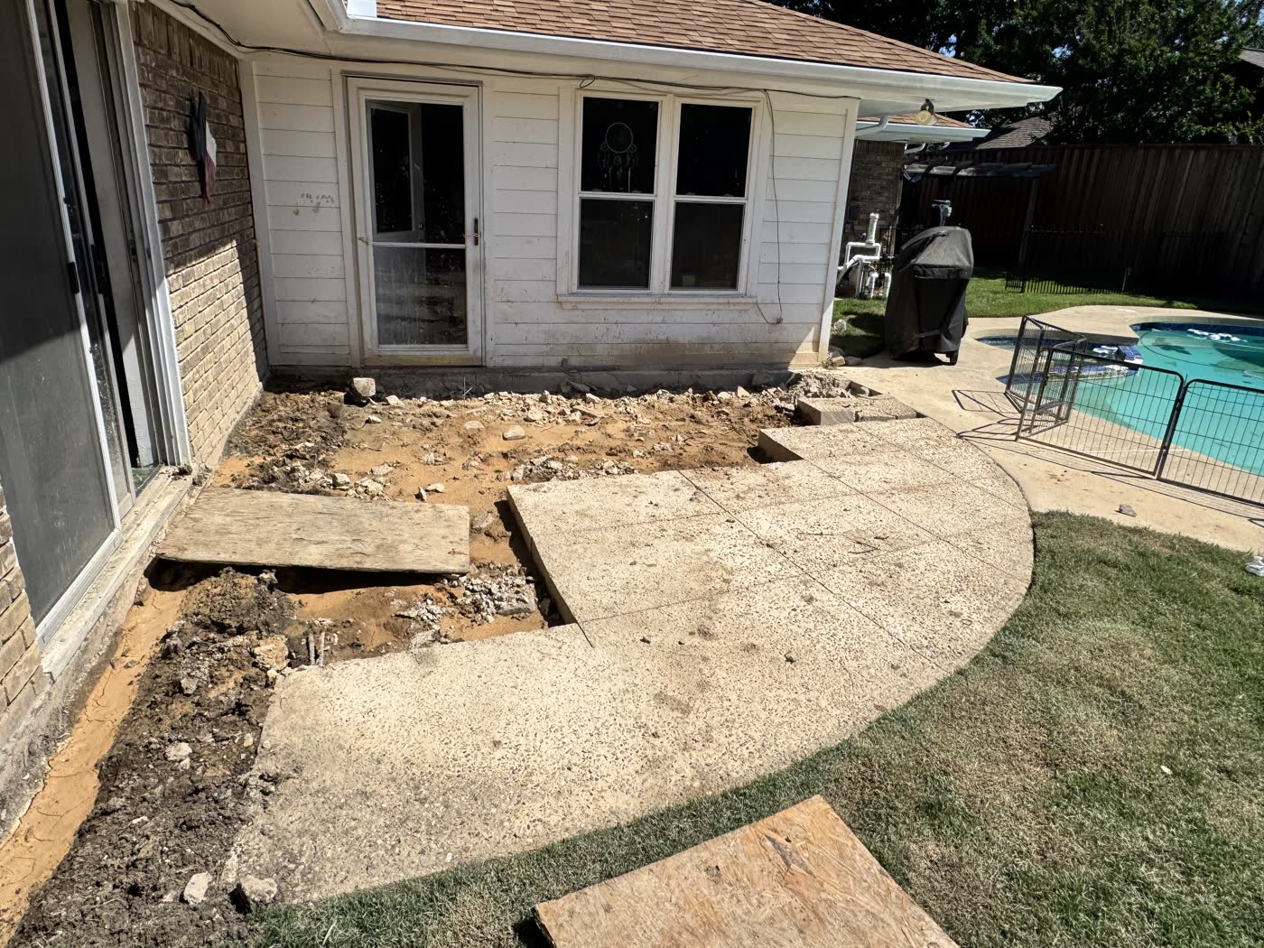 Standing water and failing patio before Waterline French drain installation near North Richland Hills, TX